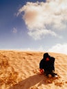 child in the Sahara desert plays with the sand of the dunes, tourist on vacation