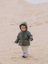 child in the Sahara desert plays with the sand of the dunes, tourist on vacation