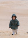 child in the Sahara desert plays with the sand of the dunes, tourist on vacation