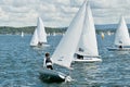 Child sailor on watch in close school children sailboat racing o Royalty Free Stock Photo