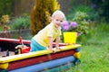 Child in sand box. Kid playing with sand Royalty Free Stock Photo