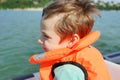 Child In a savety jacket. Water transportation background. Summer time. Royalty Free Stock Photo