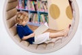 Child in school library. Kids reading books Royalty Free Stock Photo