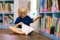 Child in school library. Kids reading books Royalty Free Stock Photo