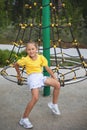 Child at school playground. Little girl has on gym activity center of preschool play ground. Healthy outdoor activity for kids. Royalty Free Stock Photo