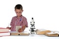 Child scientist in glasses consulting his books