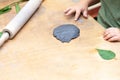 Kid craft imprint of a green leaf in black clay. Royalty Free Stock Photo