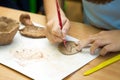 Child sculpts from clay.