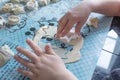 Child sculpts cookies from the dough, hands closeup