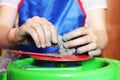 A child sculpts his hands with a clay cup on a potter`s wheel. Hands in clay. Pottery male ceramist creates a hand made clay Royalty Free Stock Photo