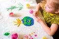 Child sculpturing plasticine planet for earth day. Protection of environment, Save our planet. Ecology concept. Concept of art Royalty Free Stock Photo