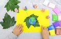Child sculpturing plasticine planet for earth day. Protection of environment, Save our planet. Ecology concept. Concept of art Royalty Free Stock Photo