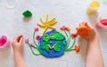 Child sculpturing plasticine planet for earth day. Protection of environment, Save our planet. Ecology concept. Royalty Free Stock Photo