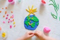 Child sculpturing plasticine planet for earth day. Protection of environment, Save our planet. Ecology concept. Concept of art Royalty Free Stock Photo