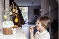 Child secretly eating Easter cake decoration topping cookies at home