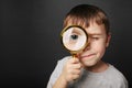 Child see through magnifying glass on the black backgrounds Royalty Free Stock Photo