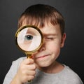 Child see through magnifying glass on the black backgrounds Royalty Free Stock Photo