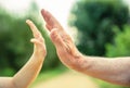 Child and senior man hands giving five in the