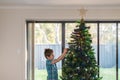 Child setting up Christmas lights