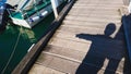 Child shadow on a wooden pier Royalty Free Stock Photo