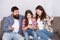 Child share news with mother and father. Little girl child use mobile phone. Happy family at home. Buy online. Child