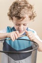 Child sharpening a pencil