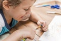 Child sharpening a pencil.