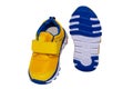 Child shoe fashion. Close-up of a pair of yellow blue child sneaker or sport shoes isolated on a white background. Elegant and Royalty Free Stock Photo