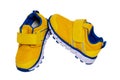 Child shoe fashion. Close-up of a pair of yellow blue child sneaker or sport shoes isolated on a white background. Elegant and Royalty Free Stock Photo