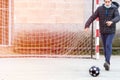 Child shooting a ball with a goal behind it