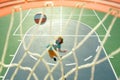 Child shooting Basketball ball and playing basketball, lower view wide angle. Basketball kids training game. Basketball