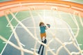 Child shooting Basketball ball and playing basketball, lower view wide angle.