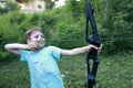 Child shooting bow in park