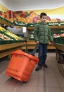 Child with a shopping car in a supermarket Royalty Free Stock Photo