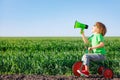 Child shouting through loudspeaker against blue summer sky Royalty Free Stock Photo