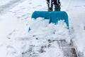 Child shoveling and removing snow in front of his house in the suburb Royalty Free Stock Photo