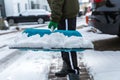 Child shoveling and removing snow in front of his house in the suburb Royalty Free Stock Photo