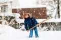 Child shoveling winter snow. Kids clear driveway Royalty Free Stock Photo