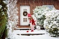 Child shoveling winter snow. Kids clear driveway.