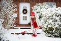 Child shoveling winter snow. Kids clear driveway Royalty Free Stock Photo