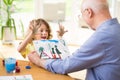 Child showing beautiful drawing to his grandfather