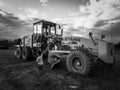 a child shows us a huge road machine. beautiful shot with background clouds