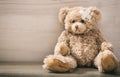 Teddy bear with bandage on a wooden floor Royalty Free Stock Photo