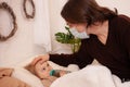 The child is sick, the father in a mask checks the temperature of his daughter. Influenza, cold, coronavirus, covid, home