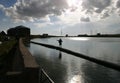 Child silhouette balancing on a jetty