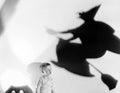 Child with silhouette of witch and jack o lantern