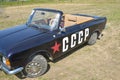 A child sits in a black car Moskvich convertible with the inscription `USSR` at an exhibition of vintage cars Royalty Free Stock Photo