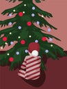 A child sits in front of a Christmas tree in a New Year\'s costume