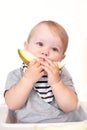 Baby 1 year old, the child himself holds and eats a melon