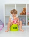 The child sits on the potty. Selective focus. Royalty Free Stock Photo
